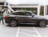 Occasions Caterers employee loads car with fresh groceries provided by their new Mobile Markets