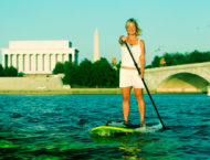 Philippa Hughes paddleboarding past the Lincoln Memorial in DC