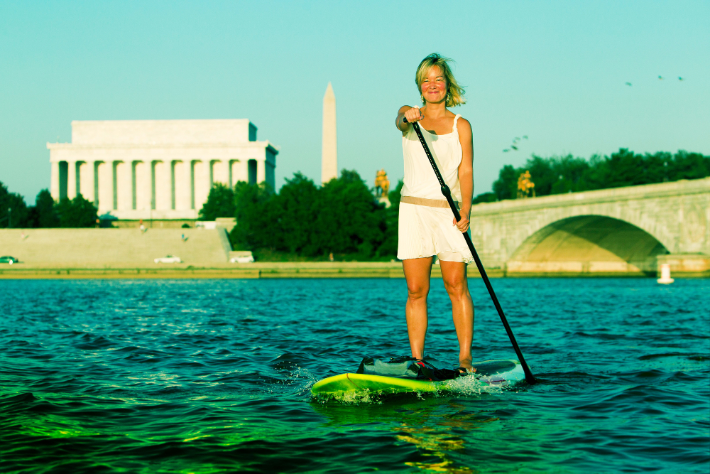 Philippa Hughes paddleboarding past the Lincoln Memorial in DC