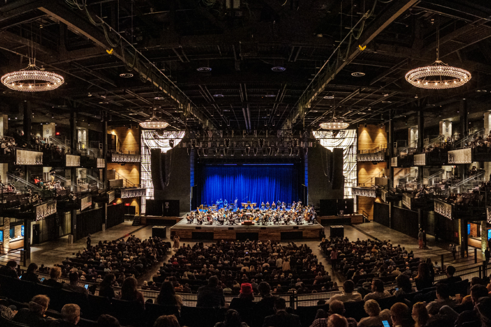 The National Symphony Orchestra plays in a large hall.