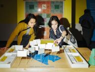 Two women look at a musuem exhibit.
