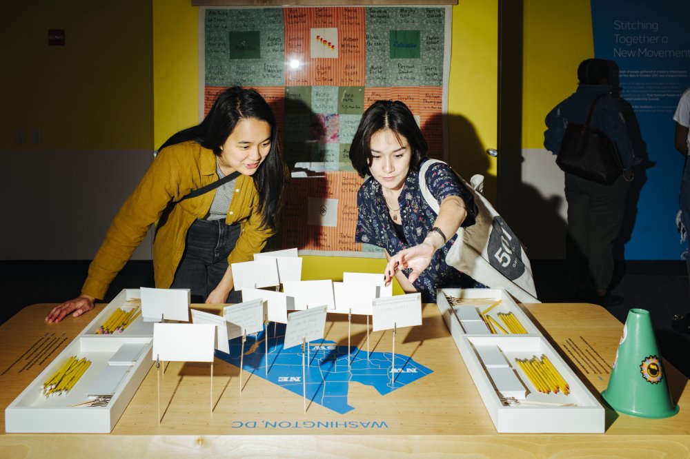 Two women look at a musuem exhibit.