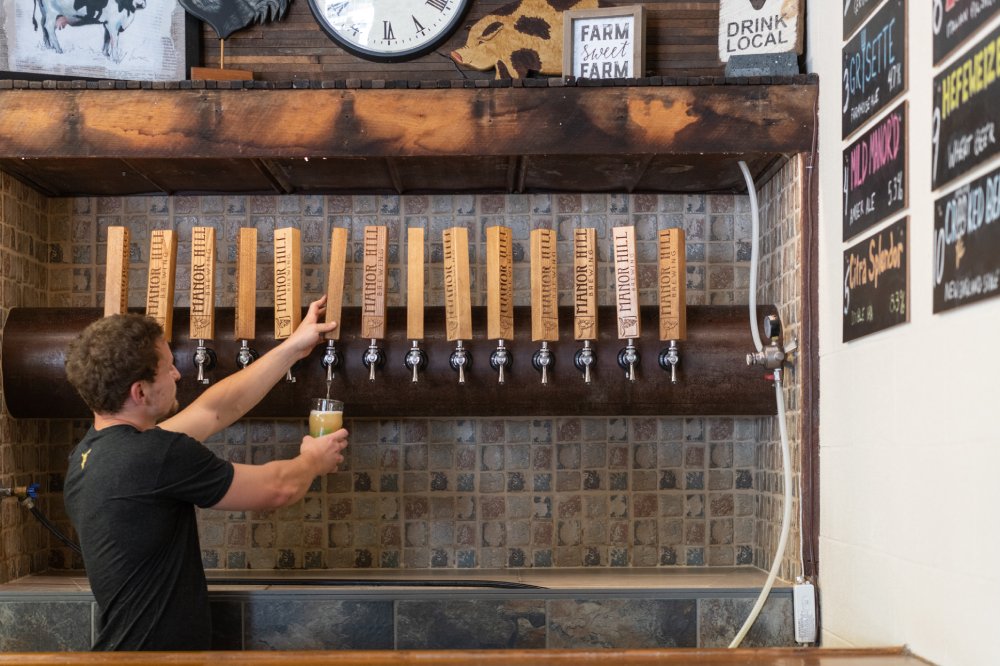 A man pours beer from a tap.