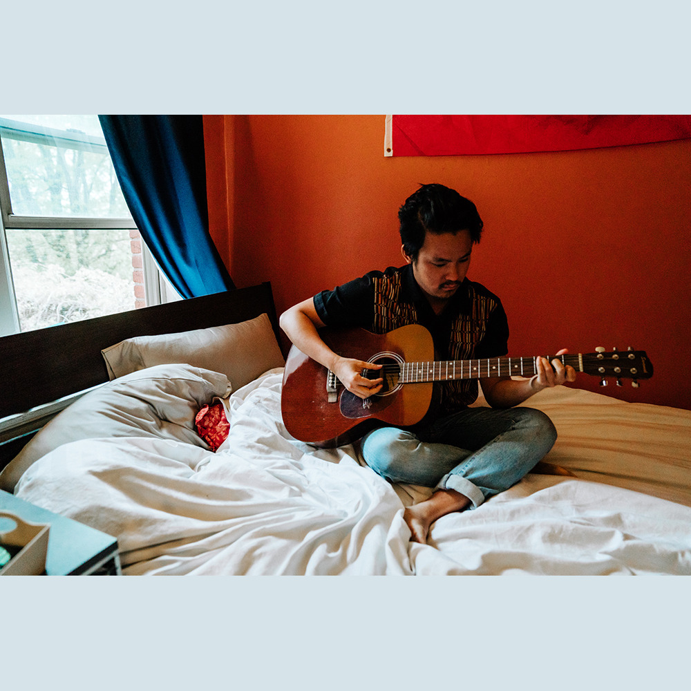 Photographer Mike Kim plays guitar. Photographer Mike Kim plays guitar.